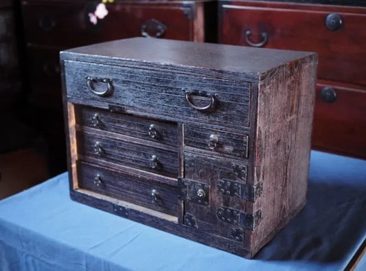 An antique small chest of drawers made of amber-colored paulownia wood from the Edo period