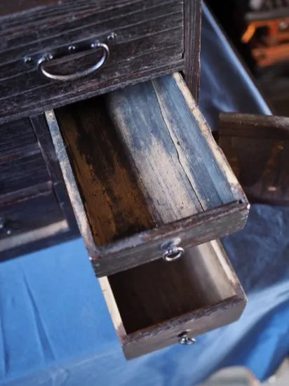 An antique small chest of drawers made of amber-colored paulownia wood from the Edo period
