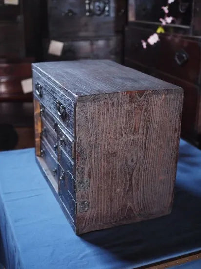 An antique small chest of drawers made of amber-colored paulownia wood from the Edo period