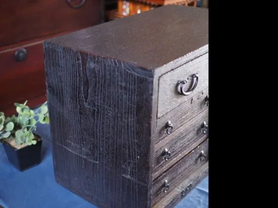 An antique small chest of drawers made of amber-colored paulownia wood from the Edo period