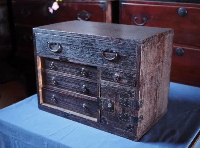 An antique small chest of drawers made of amber-colored paulownia wood from the Edo period