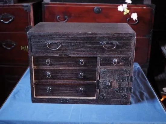 An antique small chest of drawers made of amber-colored paulownia wood from the Edo period