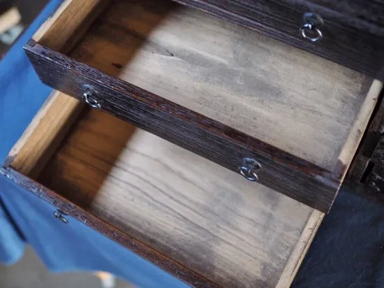 An antique small chest of drawers made of amber-colored paulownia wood from the Edo period